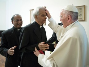 Salesian Father Thomas Uzhunnalil, from India, is blessed by Pope Francis on the occasion of their meeting at the Santa Marta residence, at the Vatican, Wednesday, Sept. 13, 2017. Uzhunnalil met with Pope Francis following his release after being kidnapped 18 months in Yemen, the Vatican newspaper l'Osservatore Romano said Wednesday. (L'Osservatore Romano/Pool Photo via AP)