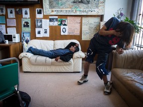 A man struggles to walk as another listens while lying on a couch during a meeting of the B.C. Association of People on Methadone in the Downtown Eastside of Vancouver, B.C., on Wednesday August 30, 2017. Drug users trying to quit heroin are gathered for a meeting in Vancouver with one mission in mind: to support each other through the struggles of a reformulated treatment drug they say hasn't worked and has instead contributed to the opioid epidemic. THE CANADIAN PRESS/Darryl Dyck