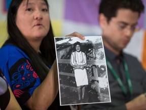 Vicki Hill holds a photo of her late mother Mary Jane Hill while testifying during hearings at the National Inquiry into Missing and Murdered Indigenous Women and Girls, in Smithers, B.C., on Tuesday September 26, 2017. Her mother was found dead along Highway 16 near Prince Rupert in 1978 at the age of 31. THE CANADIAN PRESS/Darryl Dyck