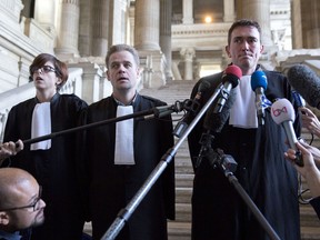 Lawyers for Mehdi Nemmouche, a French suspect in the Brussels Jewish museum attack, Henri Laquay, center, and Sebastien Courtoy, right, speak with the media at the Palace of Justice in Brussels on Thursday, Sept. 21, 2017. Mehdi Nemmouche, who is suspected of shooting dead four people at the Jewish Museum in Brussels on May 24, 2014, has complained to his lawyers that his health is deteriorating in custody. (AP Photo/Virginia Mayo)