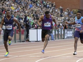 Jamaica's Yohan Blake, left, competes against Jamaica's Julian Forte, center, and USA's Isiah Young during the men's 100 meter at the Diamond League Memorial Van Damme athletics event at the King Baudouin stadium in Brussels on Friday, Sept. 1, 2017. (AP Photo/Olivier Matthys)