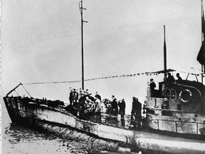 In this undated photo people stand on the deck of a First World War German submarine type UC-97 in an unknown location. Belgian regional authorities on Tuesday, Sept. 19, 2017 say that an intact German First World War submarine has been found off the coast of Belgium.