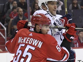 Washington Capitals left wing Alex Ovechkin, right, of Russia, battles for position against Carolina Hurricanes defenseman Roland McKeown (55) during the first period of an NHL preseason hockey game, Saturday, Sept. 23, 2017, in Washington. (AP Photo/Nick Wass)