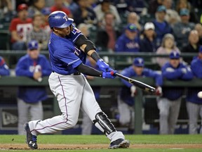 Texas Rangers' Carlos Gomez doubles in a pair of runs against the Seattle Mariners during the first inning of a baseball game Thursday, Sept. 21, 2017, in Seattle. (AP Photo/Elaine Thompson)