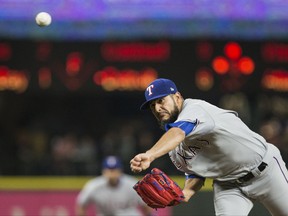 Texas Rangers starting pitcher Martin Perez (33) delivers against the Seattle Mariners in the third inning of a baseball game, Tuesday, Sept. 19, 2017, in Seattle. (AP Photo/Lindsey Wasson)