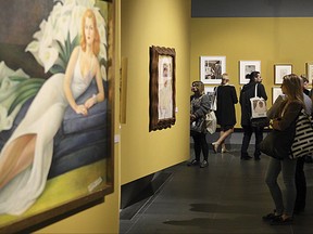 Guests attend a preview of a new exhibition on Mexican artists Frida Kahlo and Diego Rivera in Poznan, Poland, on Tuesday Sept. 26, 2017. "Frida Kahlo & Diego Rivera. Polish Context" features iconic Kahlo self-portraits, works by Rivera and the works of two Polish-born artists linked to the couple. It also recalls the mysterious disappearance of a Kahlo painting after it was displayed in Poland 62 years ago. (AP Photo/Maciej Kaczyński)