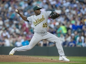 Oakland Athletics starter Jharel Cotton winds up during the first inning of a baseball game against the Seattle Mariners on Saturday, Sept. 2, 2017, in Seattle. (AP Photo/Stephen Brashear)