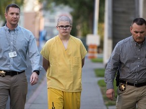 In this Wednesday, Sept. 13, 2017 photo, Spokane County Sheriff's deputies escort Caleb Sharpe from the Public Safety Building to the Juvenile Detention Center in Spokane, Wash.  Authorities say Sharpe opened fire Wednesday in a hallway at Freeman High School in Rockford, south of Spokane, killing a classmate who confronted him and wounded three others before being stopped by a custodian. (Colin Mulvany/The Spokesman-Review via AP)