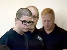 Caleb Sharpe walks into Spokane County Juvenile Court to a packed courtroom on Wednesday, Sept. 27, 2017, in Spokane, Wash. A hearing to determine whether the 15-year-old boy will be tried as an adult on charges he fatally shot a classmate and wounded three others at his rural Washington state high school will not occur until next spring, a judge said Wednesday.  (Kathy Plonka /The Spokesman-Review via AP)