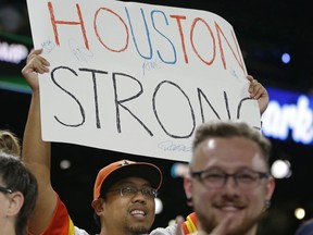 A Houston Astros fan holds a sign that reads "Houston Strong" to support victims of Hurricane Harvey following a baseball game between the Astros and the Seattle Mariners, Tuesday, Sept. 5, 2017, in Seattle. The Astros won 3-1. (AP Photo/Ted S. Warren)