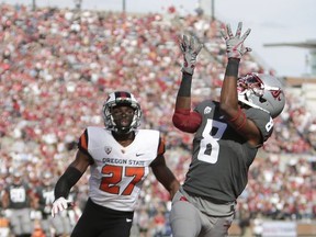 Washington State wide receiver Tavares Martin Jr. (8) catches a touchdown pass while defended by Oregon State cornerback Kyle White (27) during the first half of an NCAA college football game in Pullman, Wash., Saturday, Sept. 16, 2017. (AP Photo/Young Kwak)