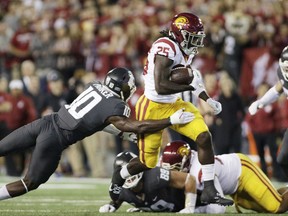 Southern California tailback Ronald Jones II (25) breaks a tackle by Washington State defensive back Kirkland Parker (10) during the first half of an NCAA college football game in Pullman, Wash., Friday, Sept. 29, 2017. (AP Photo/Young Kwak)