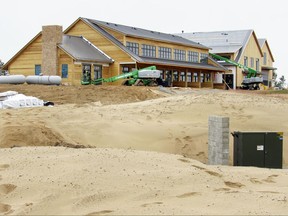 FILE - This April 12, 2017 file photo, shows the 30,000-square-foot clubhouse and lodge that overlooks the Mammoth Dunes course at Sand Valley Golf Resort in Rome, Wis. Wis. A tiny airport in central Wisconsin that's seen an influx of private jets since a Republican donor's world-class golf course opened nearby would get $4 million in improvements under funding slipped into the state budget this week. The Republican-controlled Joint Finance Committee approved the funding after the developer of the Sand Valley Golf Resort, Michael Keiser, donated $25,000 to the state Republican Party in February. (Barry Adams /Wisconsin State Journal via AP File)