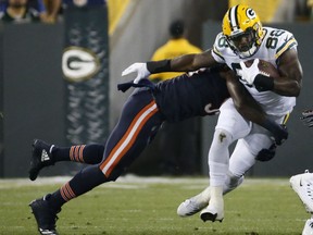 Green Bay Packers' Ty Montgomery is hit by Chicago Bears' Leonard Floyd during the first half of an NFL football game Thursday, Sept. 28, 2017, in Green Bay, Wis. (AP Photo/Mike Roemer)