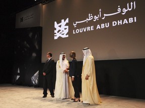 Officials gather after an announcement about the opening of the Louvre Abu Dhabi in Abu Dhabi, United Arab Emirates, Wednesday, Sept. 6, 2017. Officials on Wednesday announced that the Louvre Abu Dhabi, a Mideast outpost of the famed French museum, will open Nov. 11. (AP Photo/Jon Gambrell)