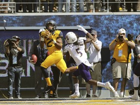 West Virginia wide receiver Ka'Raun White (2) catches a touchdown pass while being defended by East Carolina defensive back Corey Seargent (5) during the first half of an NCAA college football game, Saturday, Sept. 9, 2017, in Morgantown, W.Va. (AP Photo/Raymond Thompson)