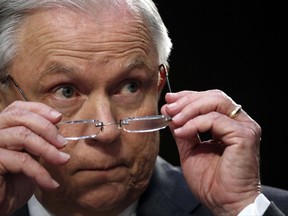 In this June 13, 2017 photo, Attorney General Jeff Sessions removes his glasses as he speaks on Capitol Hill in Washington, Twhile testifying before the Senate Intelligence Committee.  Sessions, a son of the segregated South who was named after leaders of the Confederacy, faces a tough new test of his commitment to protecting civil rights as he oversees the Justice Department's probe of the deadly violence that erupted at a rally of white nationalists in Virginia.   (AP Photo/Alex Brandon)