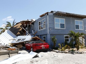 In this Sept. 13, 2017, photo, a house with its roof blown off by Hurricane Irma in Summerland Key, in the Florida Keys. Rising sea levels and fierce storms have failed to stop relentless population growth along U.S. coasts in recent years, a new Associated Press analysis shows. The latest punishing hurricanes scored bull's-eyes on two of the country's fastest growing regions: coastal Texas around Houston and resort areas of southwest Florida. (AP Photo/Wilfredo Lee)