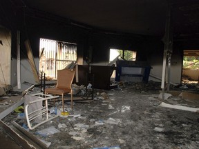 FILE - This Sept. 12, 2012 file photo shows glass, debris and overturned furniture are strewn inside a room in the gutted U.S. consulate in Benghazi, Libya, after an attack that killed four Americans, including Ambassador Chris Stevens. The trial of Ahmed Abu Khattala, the suspected mastermind of the 2012 Benghazi, Libya, attacks will be one of the biggest terrorism cases yet for the U.S. Justice Department under a leader who has said it shouldn't be handling such cases. (AP Photo/Ibrahim Alaguri, File)