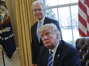 FILE - In this March 24, 2017 file photo, President Donald Trump with Health and Human Services Secretary Tom Price are seen in the Oval Office of the White House in Washington. Congress is launching a wide-ranging examination of air travel by high-ranking Trump administration officials. The House Oversight and Government Reform committee is following up on reports that health secretary Tom Price used pricey charters when cheaper commercial flights would have done.  (AP Photo/Pablo Martinez Monsivais, File)