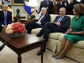 FILE - In this Sept. 6, 2017, photo, President Donald Trump pauses during a meeting with, from left, Senate Majority Leader Mitch McConnell, R-Ky., Senate Minority Leader Chuck Schumer, D-N.Y., House Minority Leader Nancy Pelosi, D-Calif., and other Congressional leaders in the Oval Office of the White House, Wednesday, Sept. 6, 2017, in Washington. The president genially calls them "Chuck and Nancy." Schumer and Pelosi, have used two White House meetings to become Trump's dealmaking partners on budget and immigration. They have a combined 67-year record of being willing negotiators in Congress. But they're also partisan Democrats perfectly happy to rumble. (AP Photo/Evan Vucci)