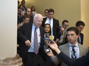 FILE - In this July 28, 2017, file photo, Sen. John McCain, R-Az., front left, is is followed by reporters after casting a 'no' vote on a a measure to repeal parts of former President Barack Obama's health care law, on Capitol Hill in Washington. Longtime friends and advisers of Sen. John McCain say they're not surprised by his decision in September to oppose a last-ditch Republican effort to overhaul the nation's health care law. McCain objected to the legislation in part because Senate GOP leaders wanted a vote without holding hearings or debate. (AP Photo/Cliff Owen, File)