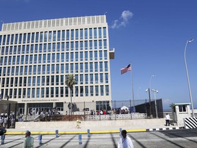 In this photo taken Aug. 14, 2015, a U.S. flag flies at the U.S. embassy in Havana, Cuba.   American diplomats who served in Cuba have been diagnosed with mild traumatic brain injury following mysterious, unexplained attacks on their health, the union that represents U.S. diplomats said Friday, in the most detailed account to date of the growing list of symptoms.  (AP Photo/Desmond Boylan)