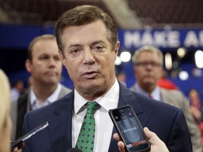 FILE - In this July 17, 2016 file photo, then-Trump Campaign Chairman Paul Manafort talks to reporters on the floor of the Republican National Convention at Quicken Loans Arena in Cleveland as Rick Gates listens at back left. Senate Judiciary Committee Chairman Chuck Grassley is considering issuing subpoenas to Manfort and two FBI officials close to fired director James Comey as part of the panel's investigation into Russian meddling in the 2016 elections.(AP Photo/Matt Rourke, File)