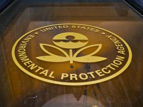 In this Sept. 21, 2017, photo, a sign on a door of the Environmental Protection Agency in Washington. The EPA says it has recovered 517 containers of "unidentified, potentially hazardous material" from highly contaminated toxic waste sites in Texas that flooded last month during Hurricane Harvey. But the agency has not provided details about which Superfund sites the material came from, why the contaminants at issue have not been identified and whether there's a threat to human health. (AP Photo/Pablo Martinez Monsivais)