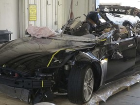 This image provided by the National Transportation Safety Board shows the damage to the left front of the Tesla involved in a May 7, 2016, crash in Williston, Fla. Investigators are meeting Sept. 12, 2017, to determine the likely cause of the crash that killed Joshua Brown, 40, of Canton, Ohio, who was using the semiautonomous driving systems of his Tesla Model S sedan. The sedan struck the underside of a semitrailer that was turning onto a divided highway in Williston. The sedan's roof was sheared off before the vehicle emerged on the other side of the trailer.(NTSB via AP)
