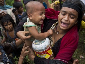 In this Sept. 8, 2017, photo, a Rohingya woman breaks down after a fight erupted during food distribution by local volunteers at Kutupalong, Bangladesh, Friday, Sept. 8, 2017. The massive refugee camp in Kutupalong was set up in the early 90s to accommodate the first waves of Rohingya Muslim refugees who started escaping convulsions of violence and persecution in Myanmar. Don't expect the United States to step in and resolve what is increasingly being describing as an ethnic cleansing campaign against Myanmar's downtrodden Rohingya Muslims. (AP Photo/Bernat Armangue)