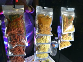 In this Sept. 11, 2017, photo,  a display of Creatos, Weed-Itz and Flavorblaster marijuana infused edibles in Washington, at a closed Ethiopian restaurant at a "gifted" marijuana event. In the so-called "District of Cannabis" it's legal to grow and consume marijuana, but illegal to buy or sell it. The result of this unique legal grey area has spawned a thriving cottage industry of businesses using the "gifting" loophole. So far the city government and police are letting it happen. (AP Photo/P. Solomon Banda)