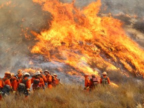 FILE - In this Sept. 2, 2017, photo, a crew with California Department of Forestry and Fire Protection (Cal Fire) battles "La Tuna" brushfire on the hillside in Burbank, Calif. With multiple intense hurricanes, a powerful earthquake, wildfires and deadly flooding from Houston to India it seems that nature recently has just gone nuts. Some of these disasters, like Friday's earthquake in Mexico, are natural. Others may end up having a mix of natural and man-made ingredients after scientists examine them.  Experts in risk and psychology said we look for patterns in overwhelming things like disasters. Sometimes there's a pattern in chaos. Sometimes there isn't.(Matt Hartman via AP)