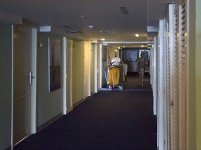 In this Sept. 12, 2017, photo, a person walks past a cleaning cart at the Hotel Capri in Havana, Cuba. New details about a string of mysterious "health attacks" on U.S. diplomats in Cuba indicate the incidents were narrowly confined within specific rooms or parts of rooms. Aside from their homes, officials said Americans were attacked in at least one hotel, the recently renovated Hotel Capri, steps from the Malecon, Havana's iconic, waterside promenade.