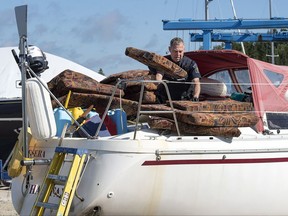 A Canada Border Services Agency officer inspects the sailboat Quesera at East River Marine in Hubbards, N.S., on Friday, Sept. 8, 2017. Approximately 273 kilograms of suspected cocaine were found on the vessel and two men were arrested. Jacques Grenier and Luc Chevrefils are facing charges including possession for the purposing of trafficking (cocaine) and conspiracy to import a controlled substance. THE CANADIAN PRESS/Andrew Vaughan
