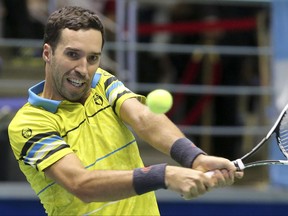 Kazakhstan's Mikhail Kukushkin returns a shot to Argentina's Diego Schwartzman, during their Davis Cup play-off tennis match in Astana, Kazakhstan, Sunday, Sept. 17, 2017. (AP Photo/Stas Filippov)