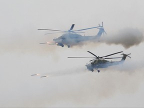 Russian military helicopters fire during a military exercise at a training ground at the Luzhsky Range, near St. Petersburg, Russia, Monday, Sept. 18, 2017. The Zapad (West) 2017 military manoeuvres have caused concern among some NATO members neighboring Russia, who have criticised a lack of transparency about the exercises and questioned Moscow's intentions.(AP Photo/Ivan Sekretarev)