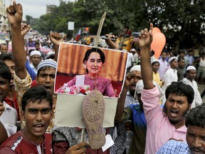Indian Muslims shout slogans as they hang a sandal across a portrait of Myanmar's State Counsellor Aung San Suu Kyi, during a protest rally against the persecution of Myanmar's Rohingya Muslim minority in Kolkata, India, Monday, Sept. 11, 2017. India has urged Myanmar to handle the situation in its Rakhine state with restraint following the exodus of hundreds of thousands of Rohingya refugees into neighboring Bangladesh. (AP Photo/Bikas Das)