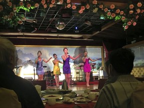 FILE - In this Feb. 18, 2016, file photo, North Korean performers entertain customers at the Okryugwan restaurant in Beijing. Chinese news reports Thursday, Sept. 28, 2017, say the government has ordered most North Korean-owned businesses and ventures with Chinese partners to close under U.N. sanctions imposed over the North's nuclear and missile programs. (AP Photo/Ng Han Guan, File)