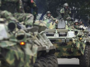 FILE - In this July 2, 2016 file photo, armored vehicles arrive after militants took hostages at a restaurant popular with foreigners in Dhaka, Bangladesh. The country is expanding its anti-terror operations with a new police unit to hunt down suspected extremists. The decision to create the new unit follows several years of deadly attacks targeting writers, atheists, foreigners and other perceived enemies of Islam, though there have been no major attacks since July 2016. Experts said Thursday, Sept. 28, 2017, the move would help maintain security control. (AP Photo/File)