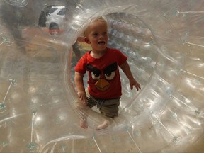 Winner of a Mr. Dwarf competition, Adriaan Coetzee, plays in a plastic air bubble during a weekend dwarf festival in Modimolle, South Africa, Saturday, Sept. 9, 2017. The event this past weekend drew dwarves from around the country and was an opportunity to share experiences, and discuss challenges and ways to overcome them. (AP Photo/Denis Farrell)