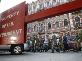 Russian cadets walk past the U.S. consulate in St.Petersburg, Russia, Friday, Sept. 1, 2017. Russian Foreign Minister Sergey Lavrov says Moscow has yet to study the United States' decision to shut its consulate in San Francisco before considering possible retaliation. (AP Photo/Dmitri Lovetsky)