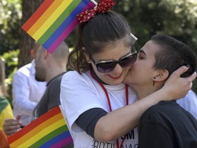 Women kiss during a gay pride march in Podgorica, Montenegro, Saturday, Sept. 23, 2017. About 200 people have gathered at a pride event in staunchly conservative Montenegro urging more rights and zero tolerance for violence against the Balkan country's embattled gays. (AP Photo/Risto Bozovic)