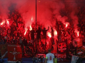 Spartak supporters light a flare during the Champions League soccer match between Maribor and Spartak Moscow at the Ljudski vrt stadium, in Maribor, Slovenia, Wednesday, Sept. 13, 2017. (AP Photo/Darko Bandic)