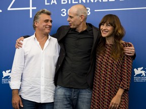 Director Samuel Maoz, center, and actors Lior Ashkenazi, left, and Sarah Adler pose during the photo call for the film "Foxtrot" at the 74th Venice Film Festival in Venice, Italy, Saturday, Sept. 2, 2017. (AP Photo/Domenico Stinellis)