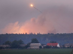 A powerful explosion is seen in the ammunition depot at a military base in Kalynivka, west of Kiev, Ukraine, early Wednesday, Sept. 27, 2017.  Ukrainian officials say they have evacuated more than 30,000 people after a fire and ammunition explosions, at the military base on Tuesday. (AP Photo/Efrem Lukatsky)