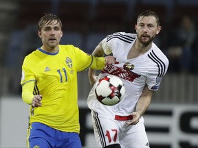 Sweden's Christoffer Nyman, left, struggles for the ball with Belarus' Mikhail Sivakov during the World Cup Group A qualifying soccer match between Belarus and Sweden at the Borisov-Arena stadium, in Borisov, Belarus, Sunday, Sept. 3, 2017. (AP Photo/Sergei Grits)