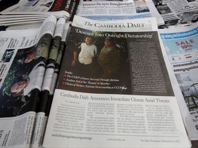 The final issue of The Cambodia Daily is sold at a newsstand, in Phnom Penh, Cambodia, Monday, Sept. 4, 2017.  When Cambodia's main opposition leader was arrested over the weekend in a surprise police raid, one of this country's last independent media outlets rushed reporters out in the middle of night to cover the story, just as it has done for nearly a quarter-century. But the English-language Cambodia's Daily's reportage about the arrest of Kem Sokha, who stands accused by the government of treason, was a tragic story in and of itself: It was on the front page of the paper's final issue Monday. (AP Photo/Heng Sinith)