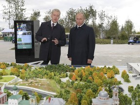 Russian President Vladimir Putin, right, and Moscow Mayor Sergei Sobyanin visit the Zaryadye Park in Moscow, Russia, Saturday, Sept. 9, 2017. With a visit from President Putin, Moscow has inaugurated an innovative 32-acre (13-hectare) Zaryadye Park that mimics features of Russia's landscape on land where a notoriously unsightly hotel once sprawled, coming as part of observances commemorating Moscow's 870th anniversary. (Alexei Druzhinin, Sputnik, Kremlin Pool Photo via AP)