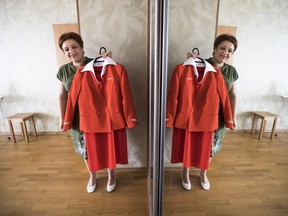 FILE - In this file photo taken on Thursday, Aug. 3, 2017, Aeroflot flight attendant Yevgeniya Magurina shows her uniform during an interview with the Associated Press in Lobnya, outside Moscow, Russia.  A Moscow court has ruled in favor of Magurina who claimed that Russia's flagship airline Aeroflot discriminated against her based on appearance.. (AP Photo/Alexander Zemlianichenko, FILE)